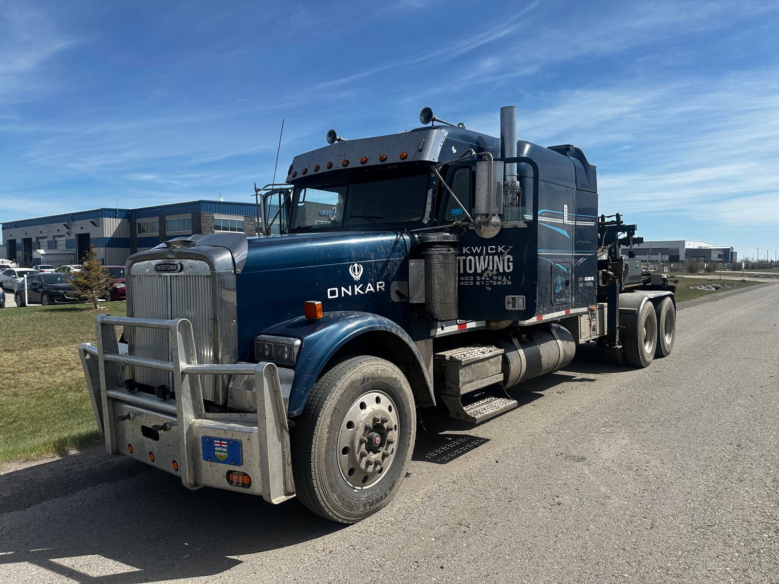 Tow truck operated by 1Onkar Towing & Recovery providing emergency towing in Calgary